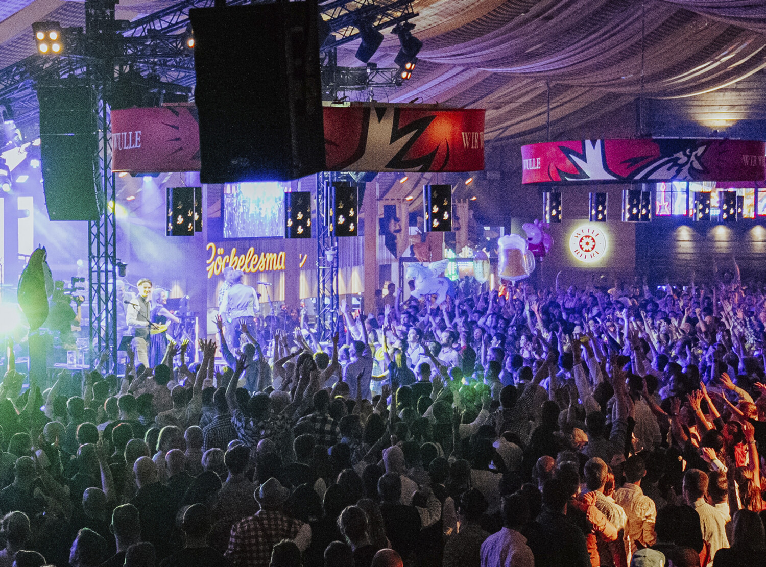 A crowd celebrating in a beer tent