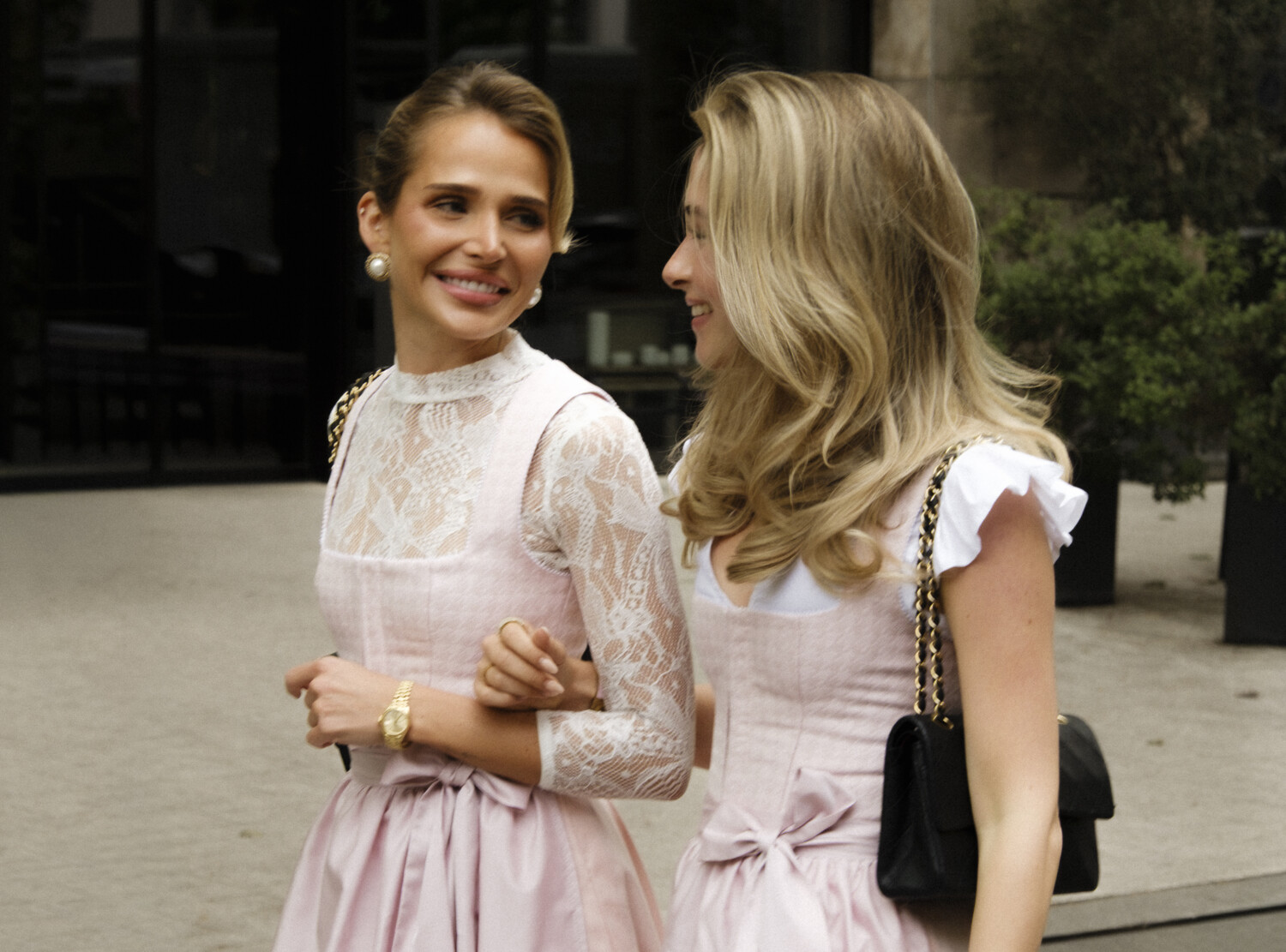 Two ladies in Dirndls walking arm in arm