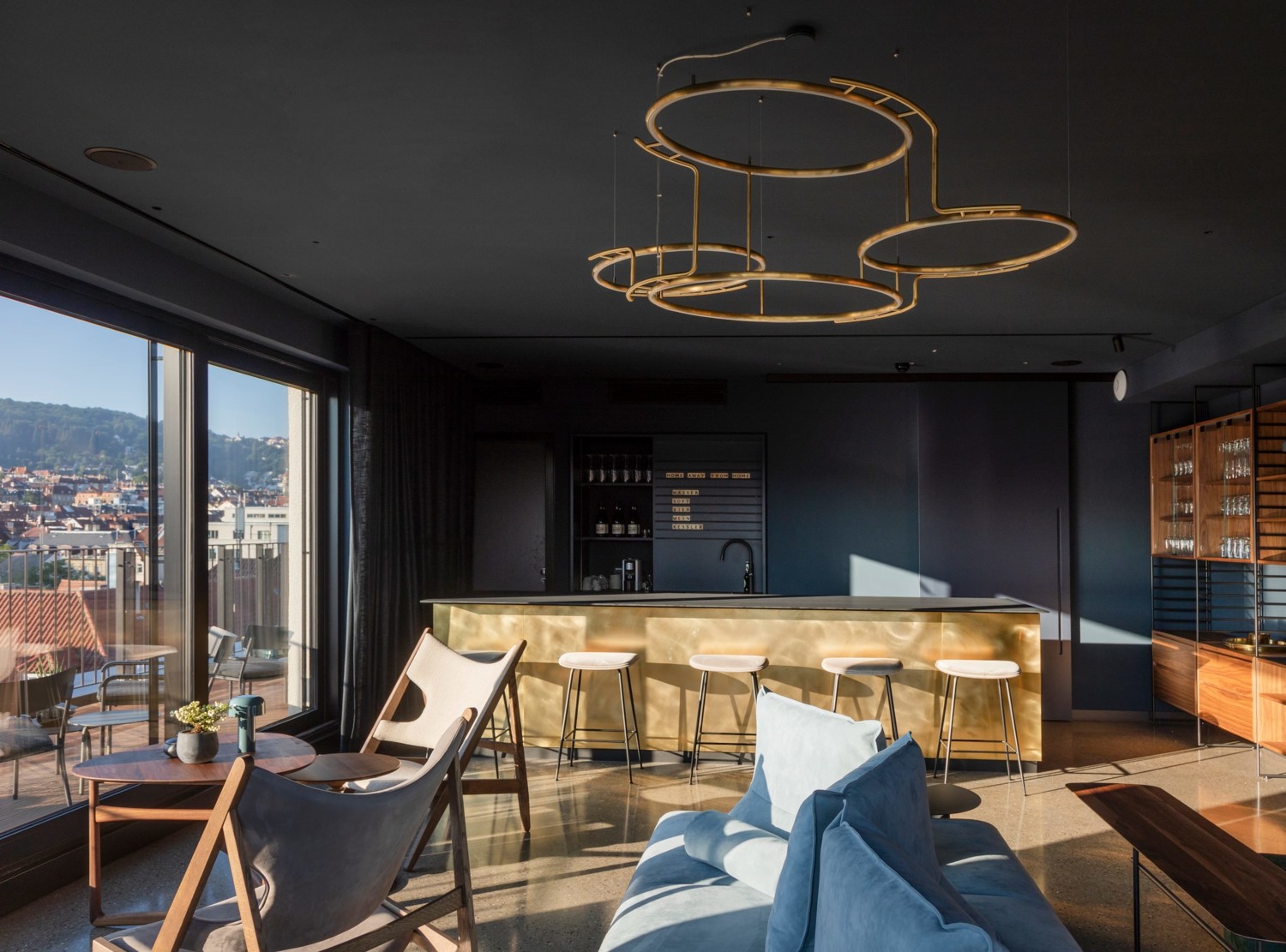 Design-Bar in Gold-Optik in einem eleganten, aber gemütlichen Lounge-Bereich