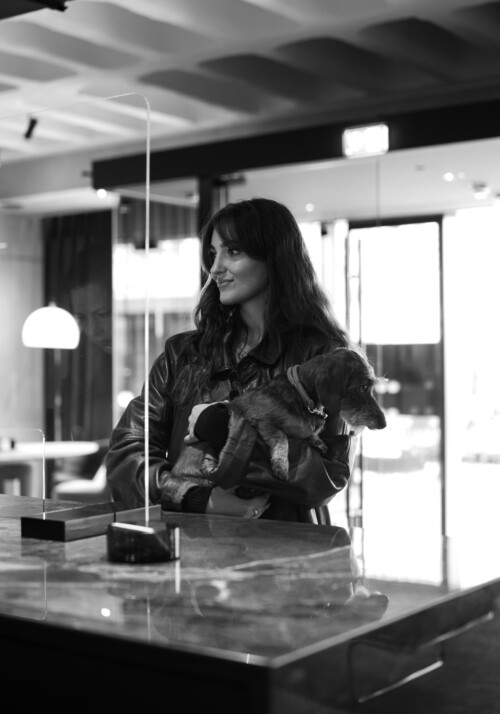 Black and white picture of a women waiting at the reception