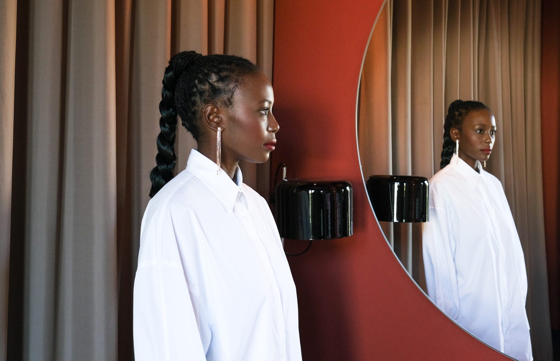 Women in a white blouse facing a mirror