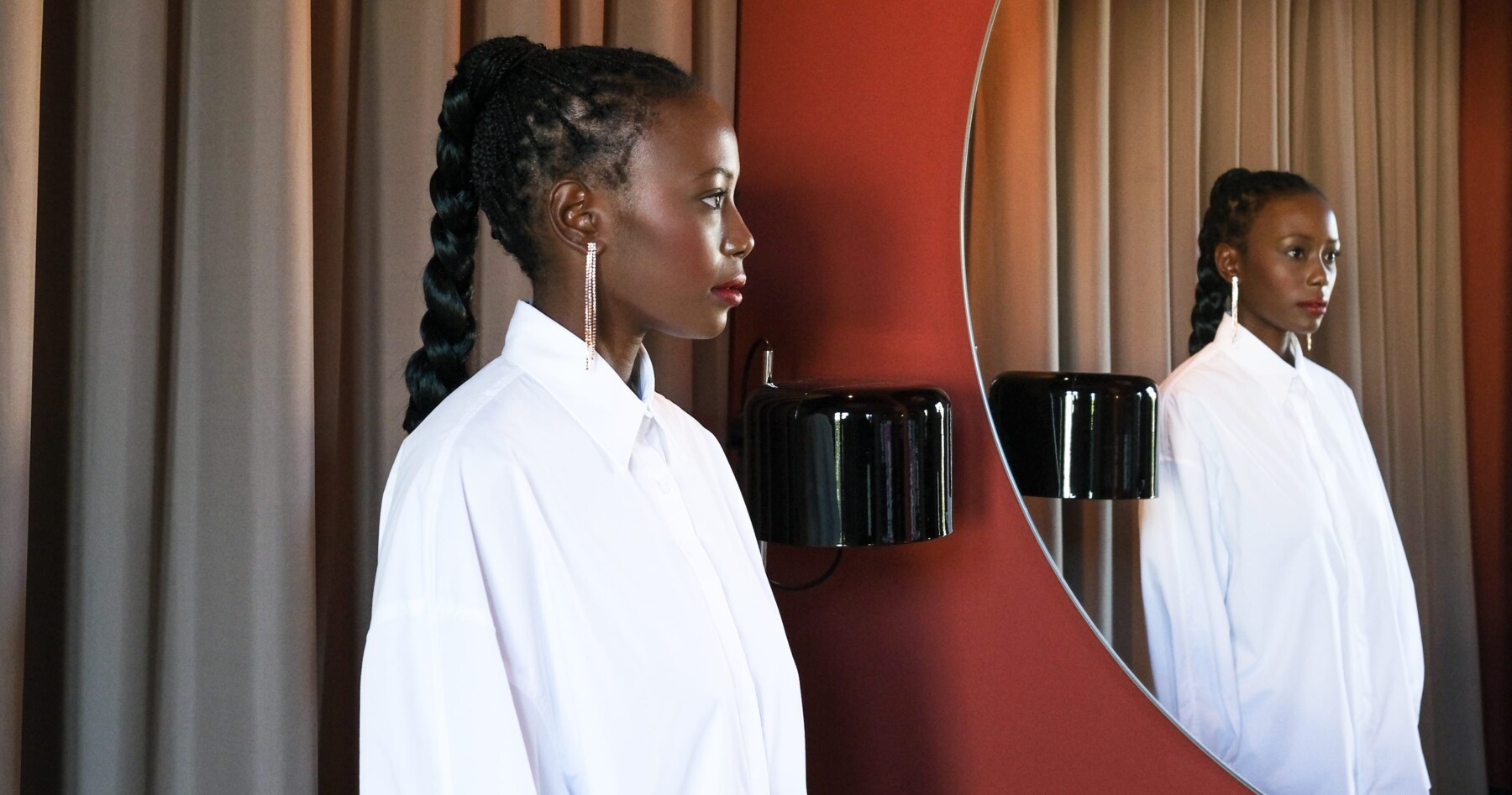 Women in white blouse facing a mirror