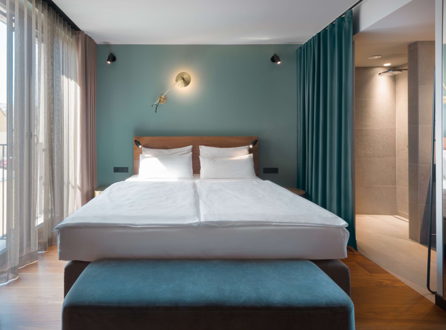Front view of the bed in a backstage room in green colours
